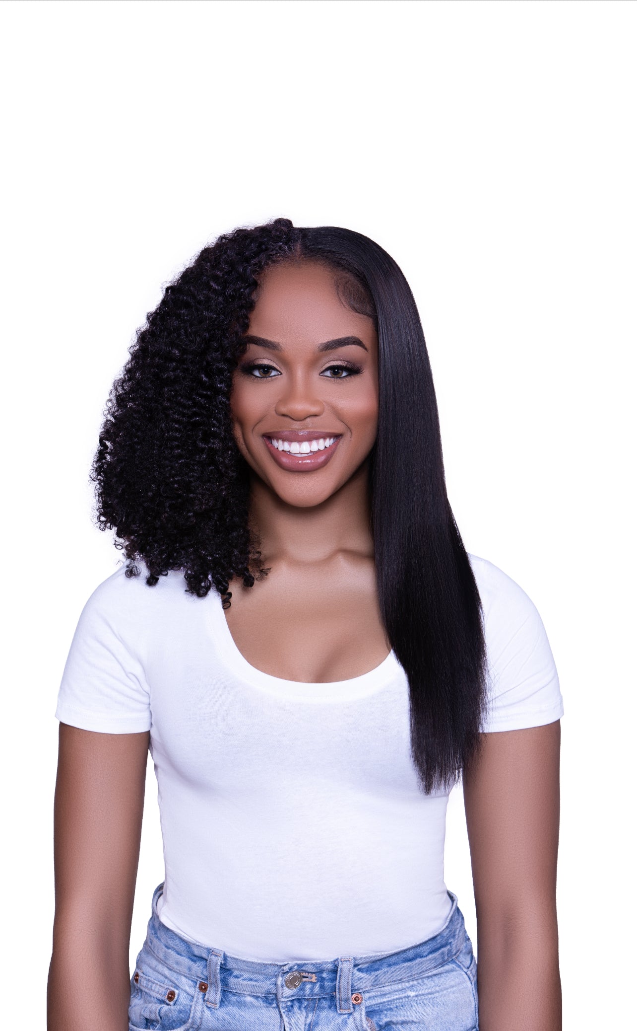 smiling woman with kinky hair clips ins one half kinky curly and one half straightened