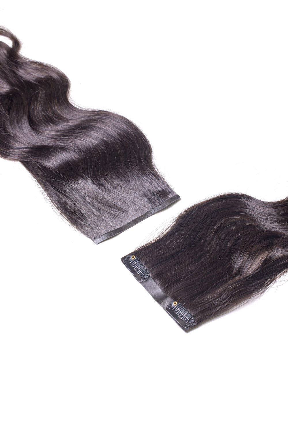 Top view of a flat lay featuring 8 pieces of dark brown Venus Body Wave seamless clip-in hair extensions with visible silicone clips; arranged on a neutral background to highlight texture and fullness.