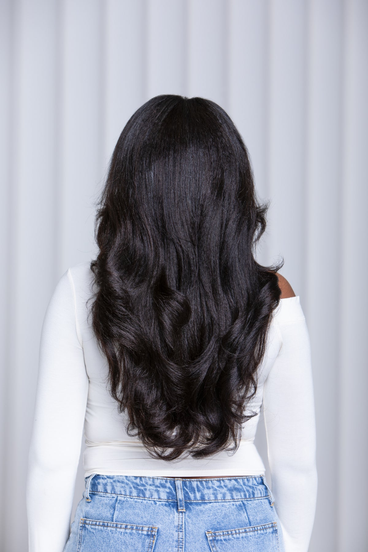 Back view of Go Sleek Calli kinky straight 20 inch U-part wig styled in voluminous curls, showing full length and density