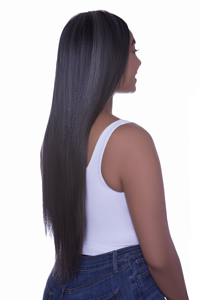 A woman with gray hair featuring clip-in hair extensions that are blends of dark brown and beige hues.