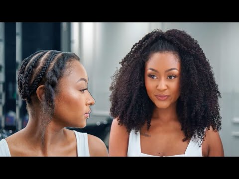 Woman installing the ‘Kai’ Kinky Curly Half Wig, securing the combs at the crown and back while blending the natural leave-out for a seamless finish.