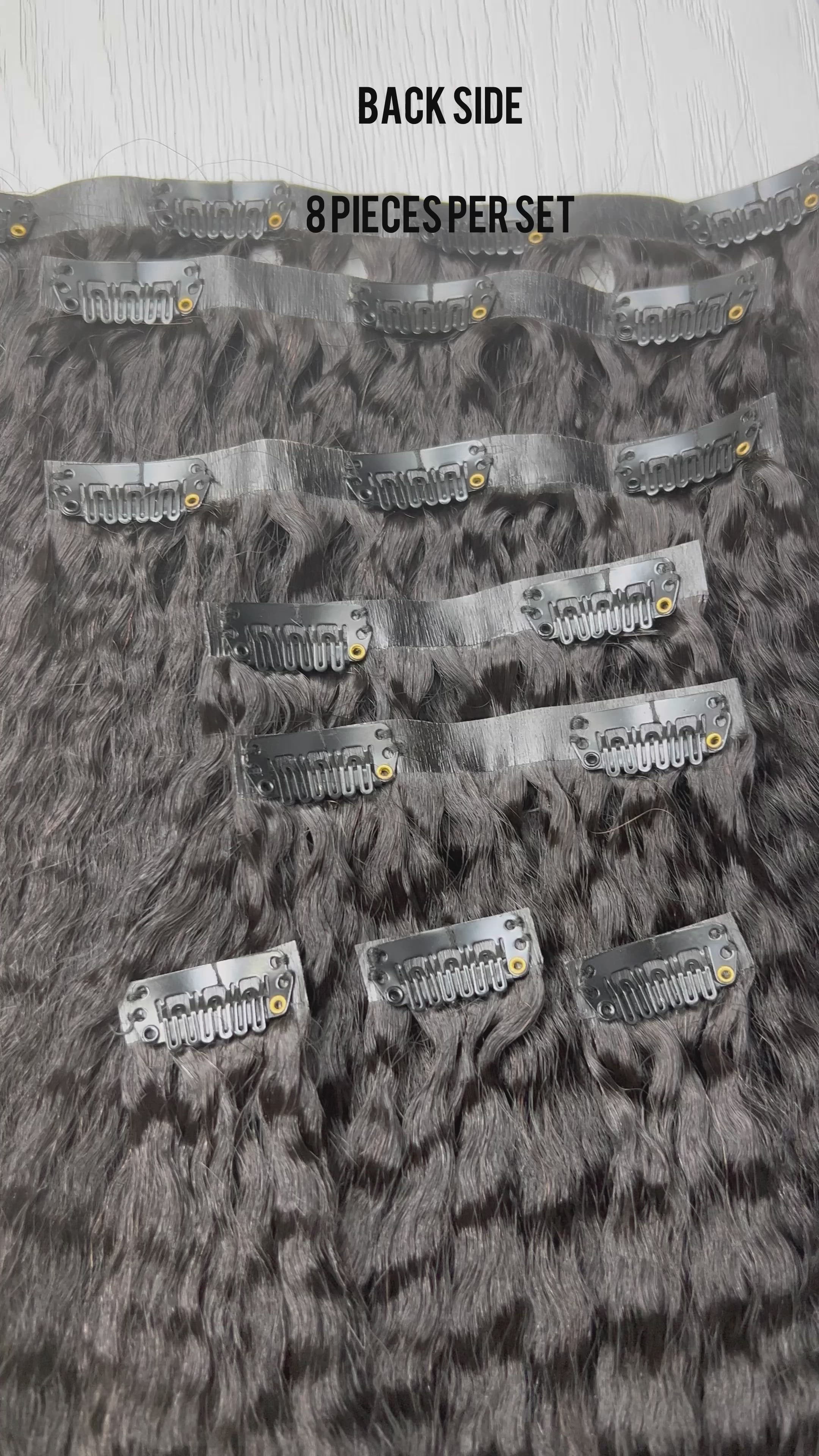 Top view flat lay of Go Sleek’s Seamless Kinky Straight Clip-Ins, showing 8 separate wefts with visible clips. Each piece features a natural kinky straight texture and seamless, flat bases designed for undetectable blending.