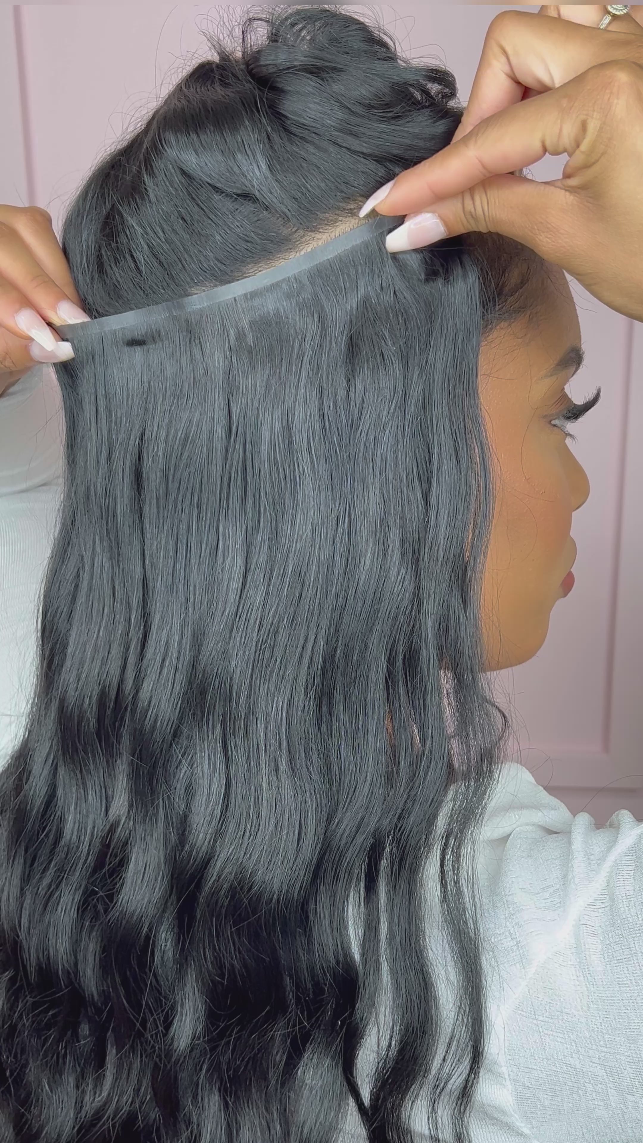 video of woman installing Seamless Clip-Ins: “Venus” Body Wave