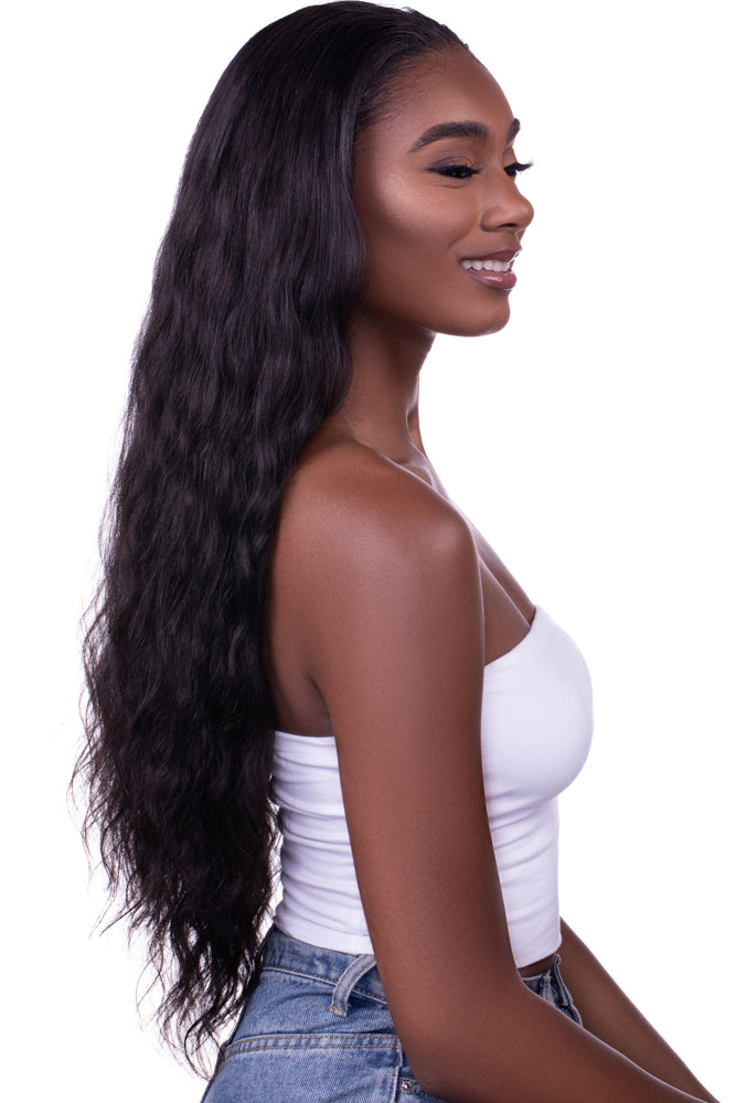 Woman wearing “Venus” Body Wave Seamless Clip-In Hair Extensions, styled in long, flowing waves with a natural luster, showcasing the soft texture and volume of the 100% virgin hair blend.