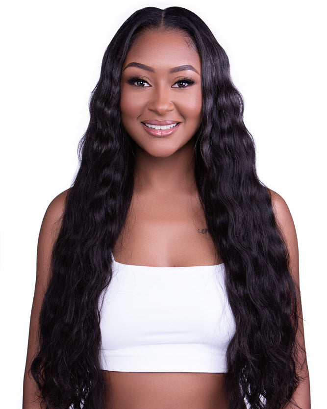 Woman wearing Go Sleek Burmese Body Wave hair bundle styled in loose, natural waves; showcasing soft luster and full volume with a natural dark brown color.